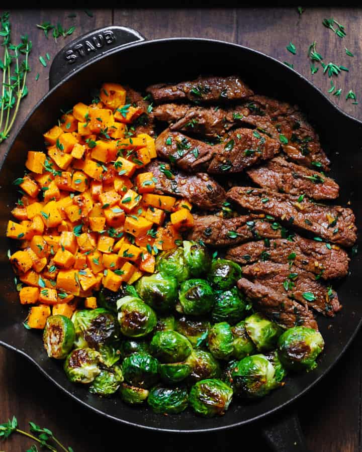 Garlic Butter Steak with Brussels Sprouts and Butternut Squash in a cast-iron skillet