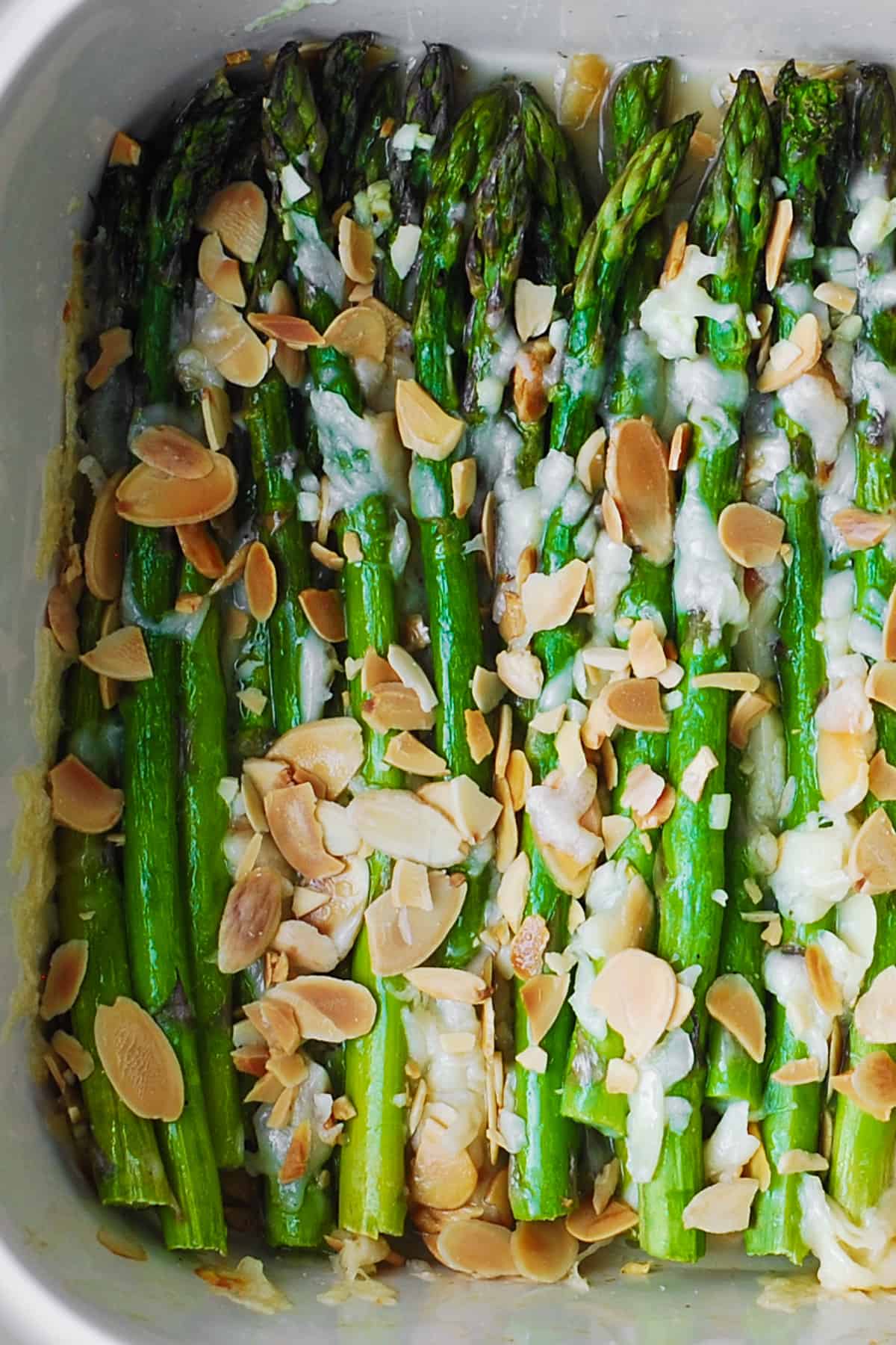 Roasted Asparagus with Almonds and Parmesan in a white baking dish