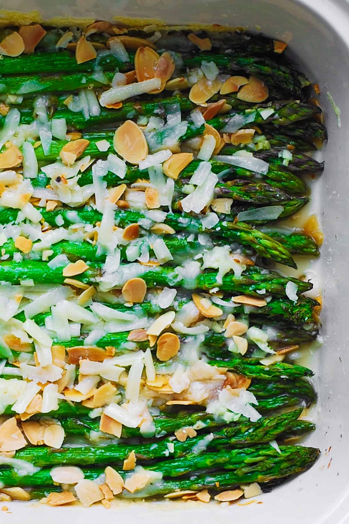 Roasted Asparagus with Almonds and Parmesan in a white baking dish