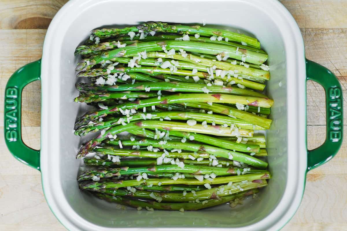 asparagus with chopped garlic in a baking dish
