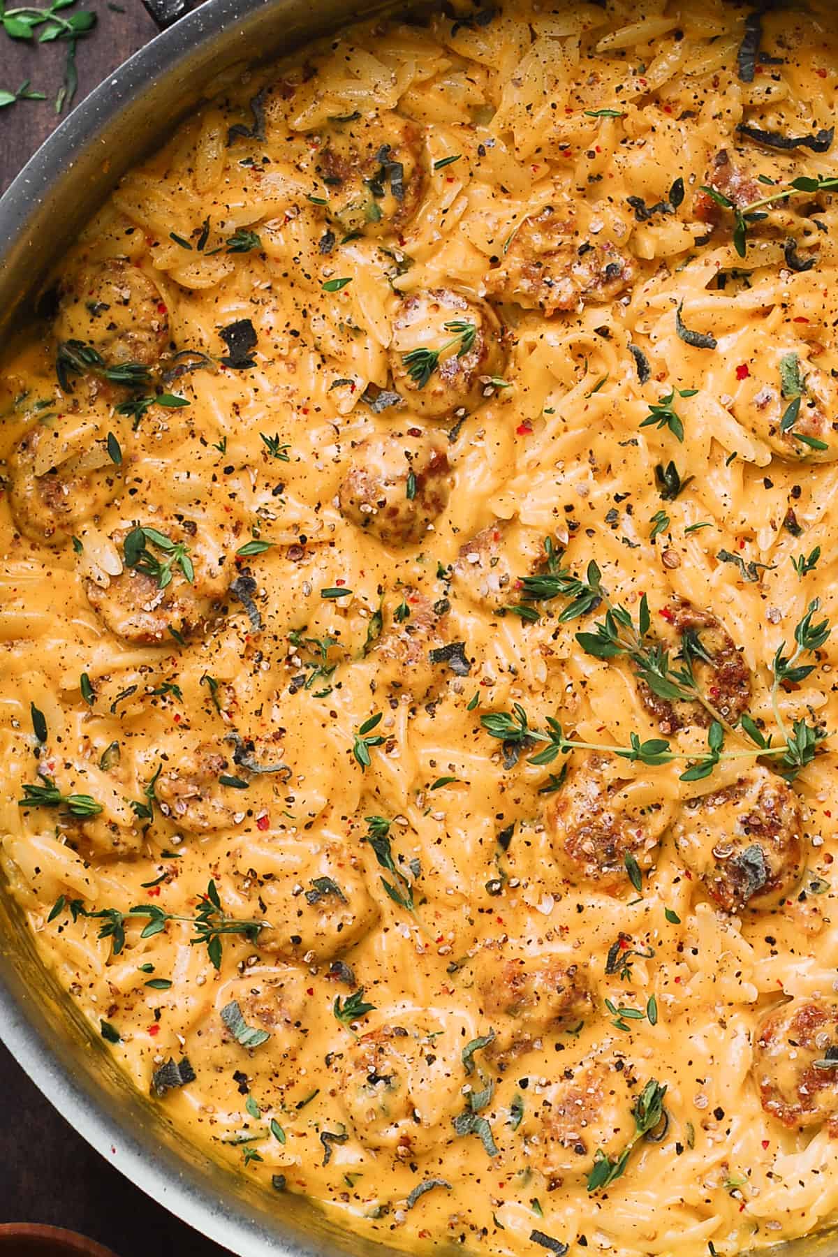 butternut squash orzo with sausage in a stainless steel pan