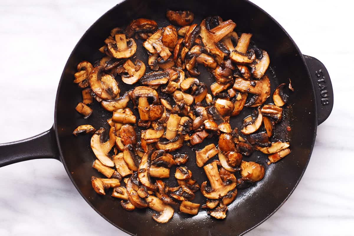 cooked mushrooms in a cast-iron skillet