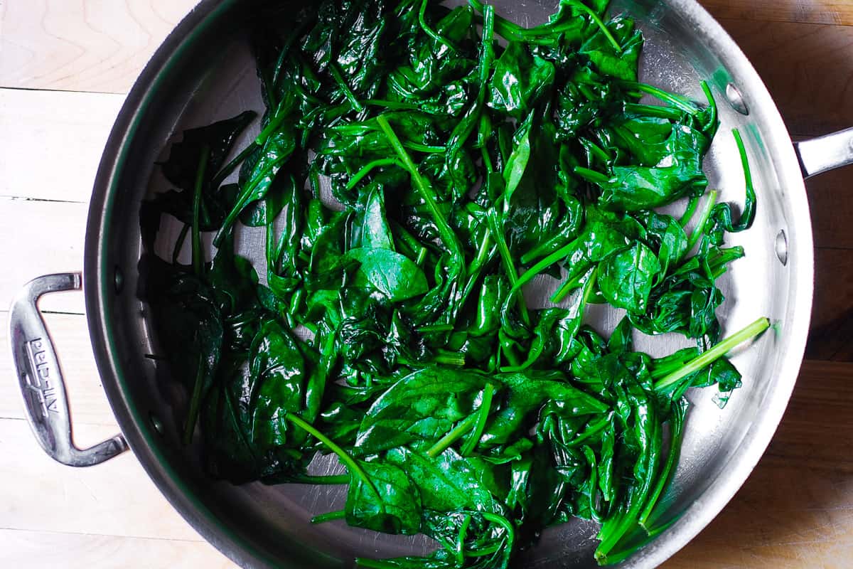 cooked spinach in a stainless steel pan