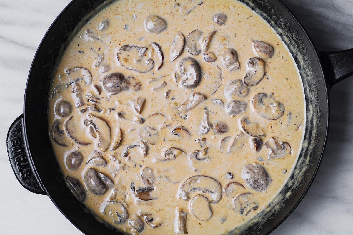 creamy mushroom sauce in a cast-iron skillet