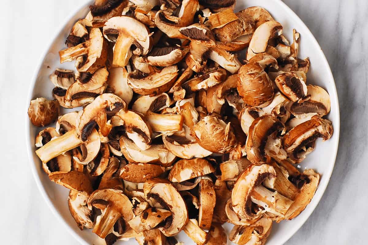 sliced mushrooms on a white plate