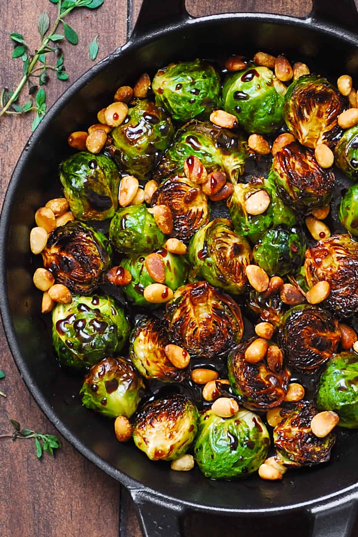 Balsamic Brussels sprouts with pine nuts in a cast-iron pan