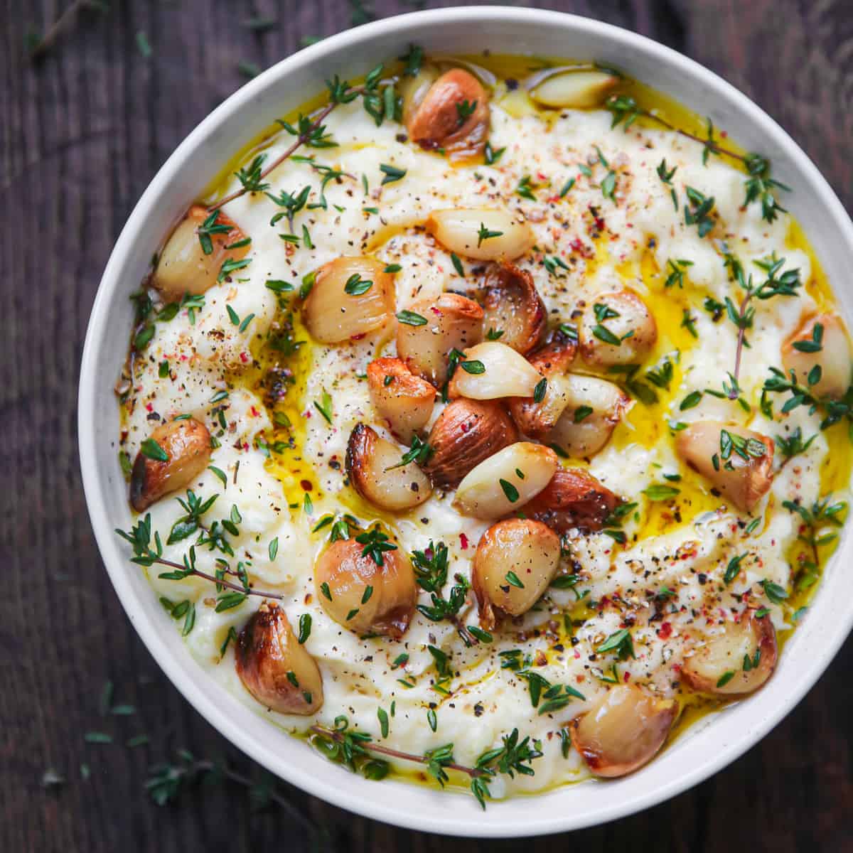 mashed potatoes with roasted garlic in a white bowl