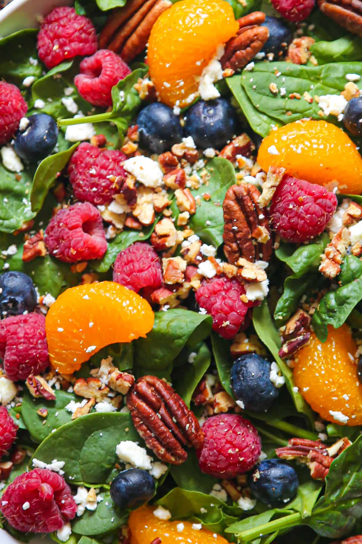 berry spinach salad with blueberries, raspberries, pecans, feta cheese, and balsamic glaze