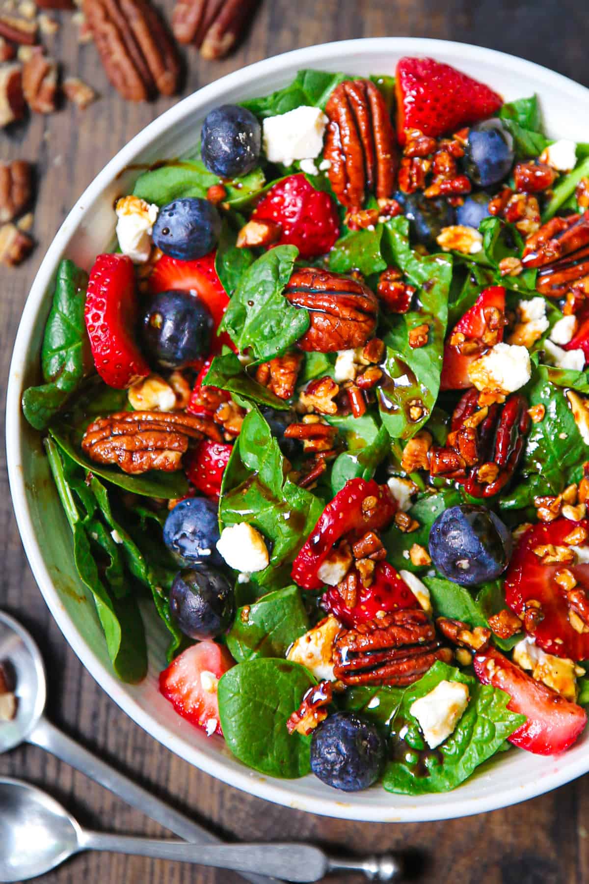 strawberry spinach salad with pecans, feta cheese, and balsamic salad dressing