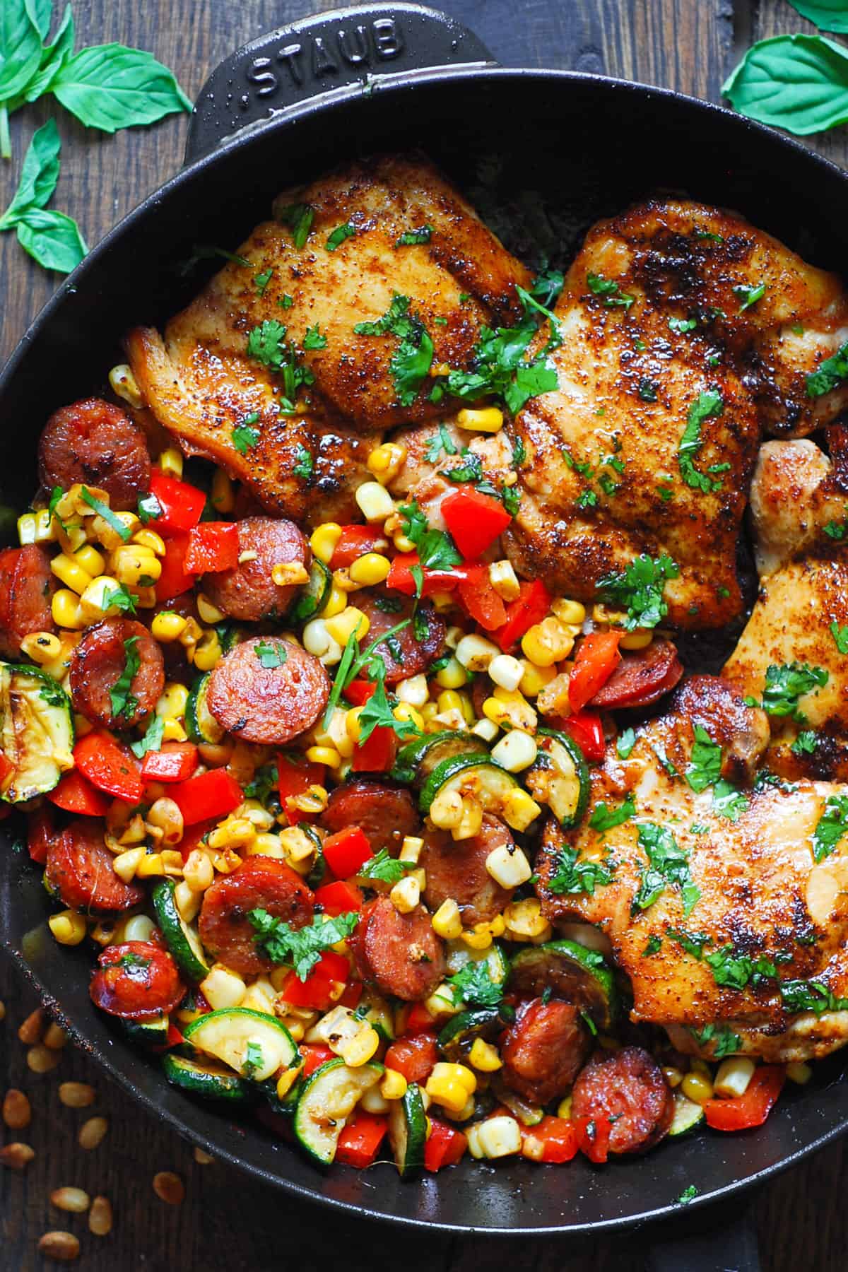 Chicken Sausage and Vegetable Skillet with Corn, Zucchini, and Bell Peppers in a cast iron pan