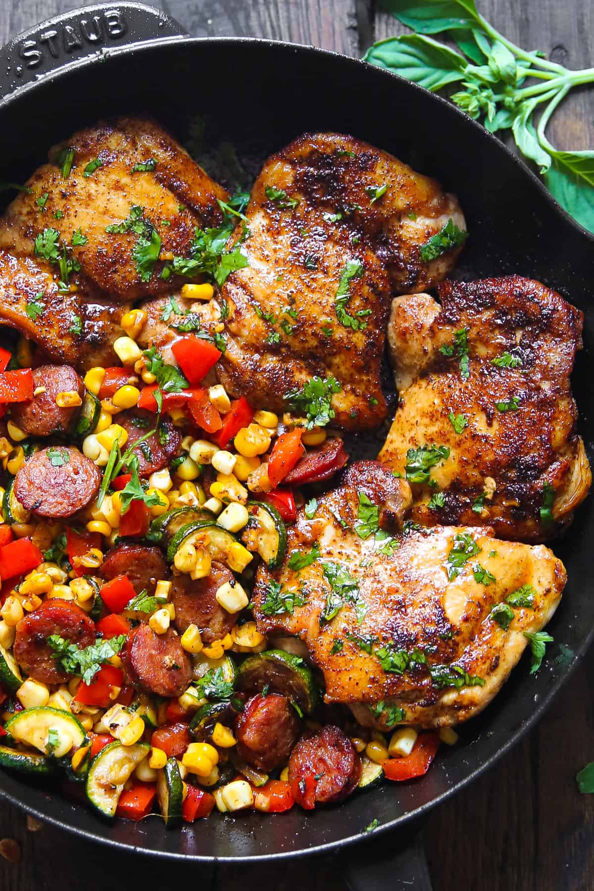 Chicken Sausage and Vegetable Skillet with Corn, Zucchini, and Bell Peppers in a cast iron pan