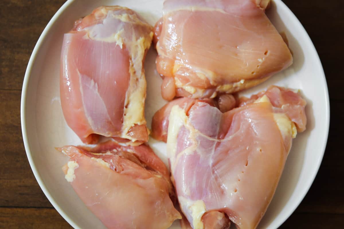 raw chicken thighs on a plate