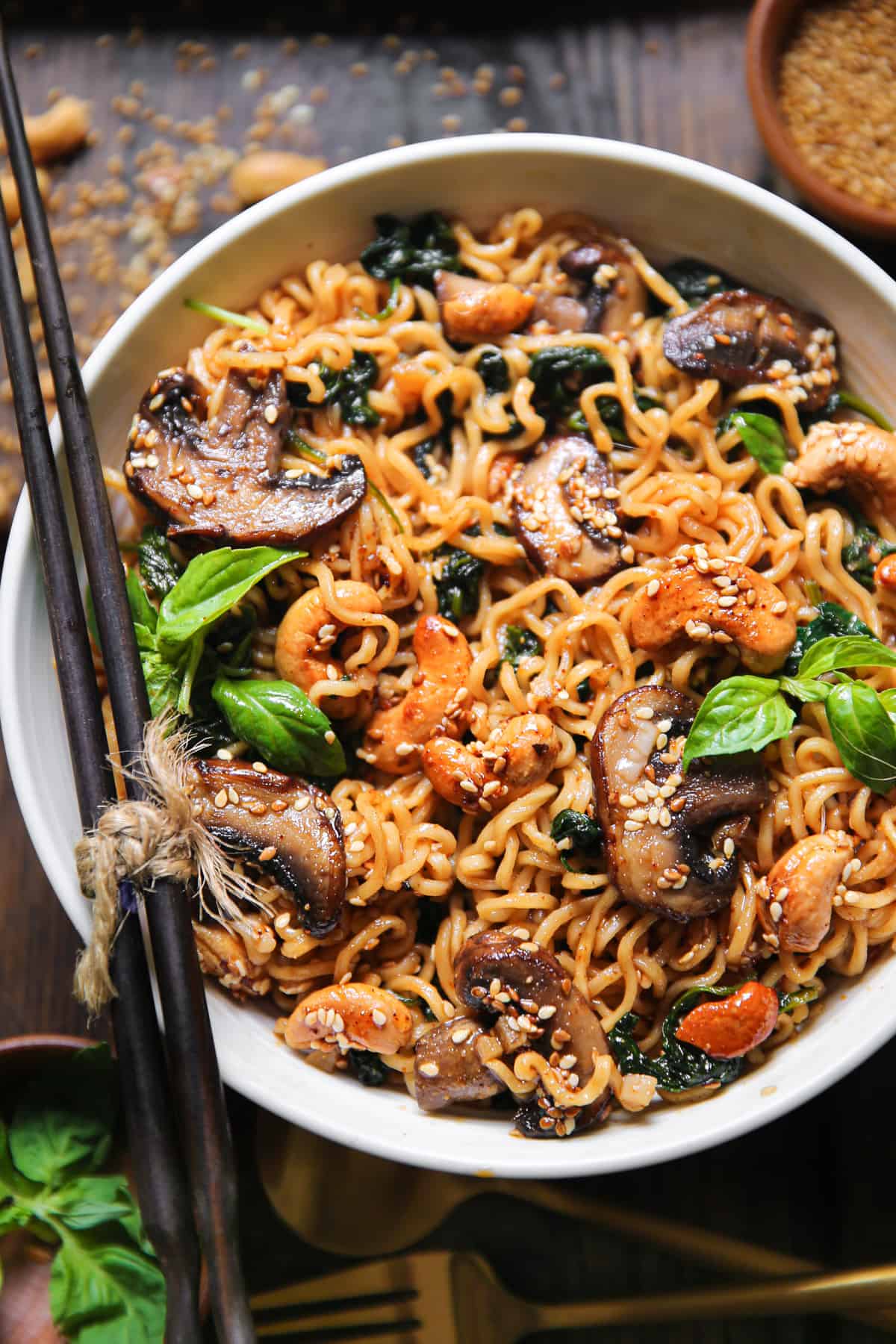 vegetarian ramen noodles with mushrooms, spinach, and cashews in a bowl