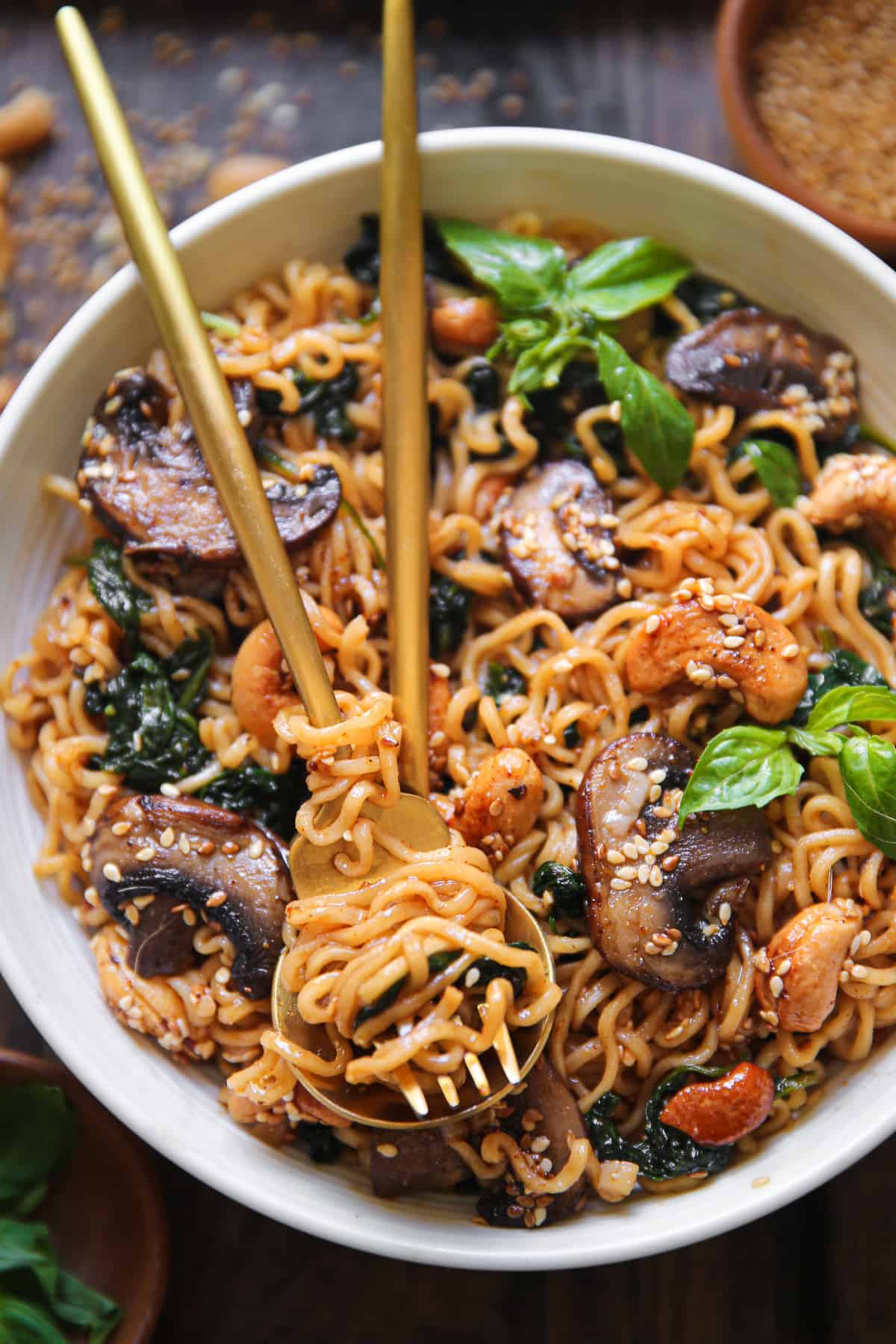 vegetarian ramen noodles with mushrooms, spinach, and cashews in a bowl