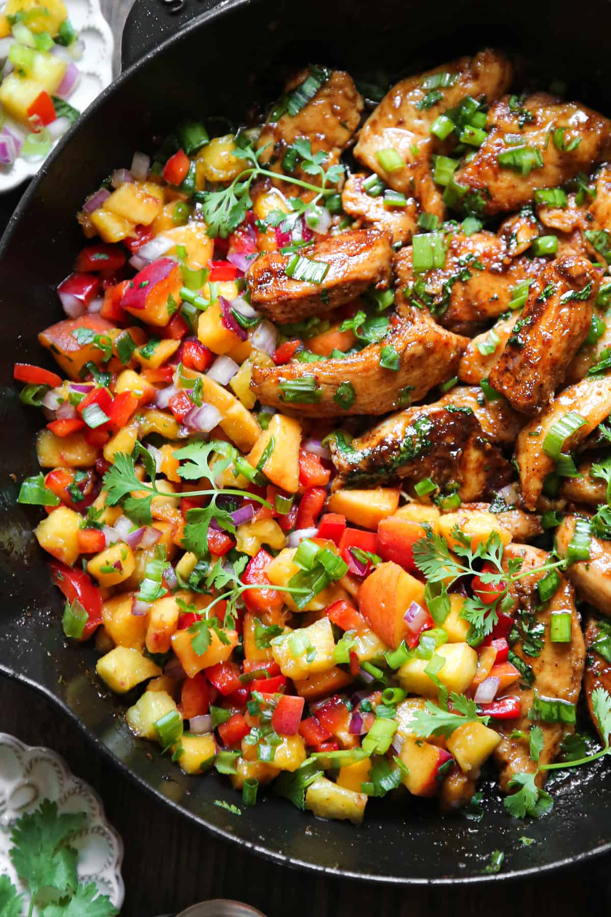 Cilantro-Lime Chicken with Peach Salsa in a cast iron skillet