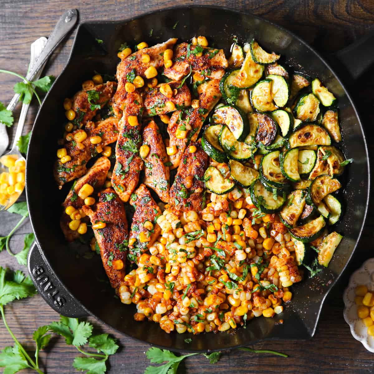 Garlic Butter Chicken with Zucchini and Corn in a cast iron skillet