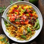 Asian Glazed Salmon with Mango Peach Salsa and Pasta in a white bowl