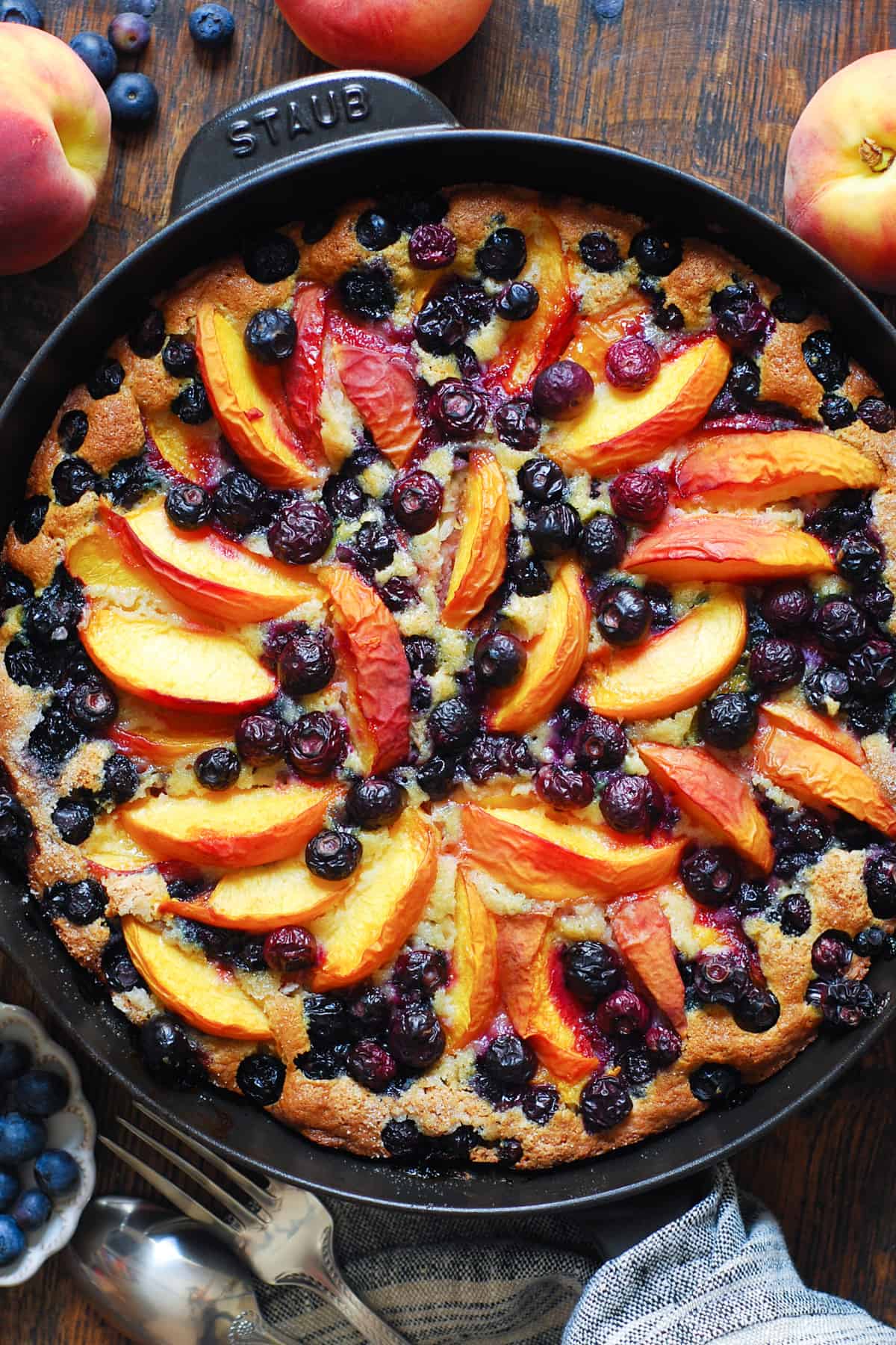 peach blueberry skillet cake in a cast iron skillet