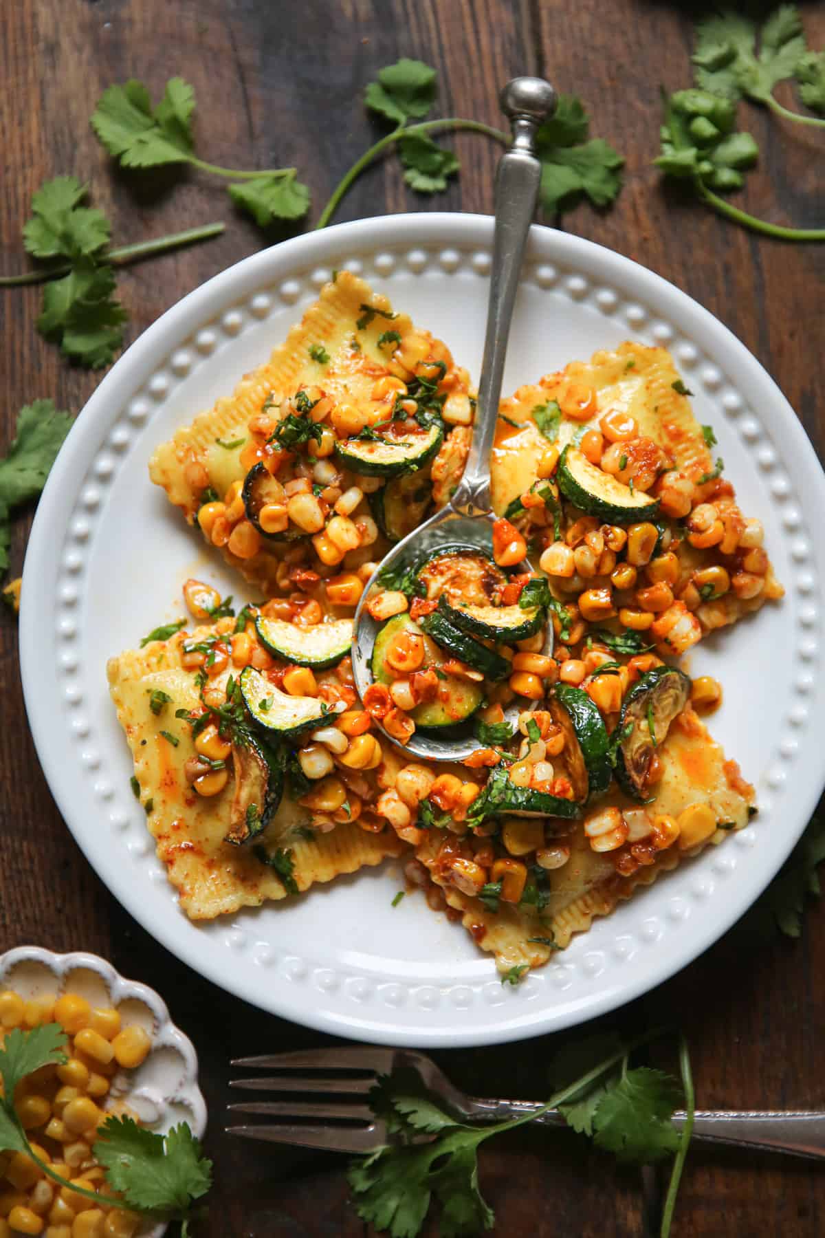 ravioli with corn and zucchini on a white plate