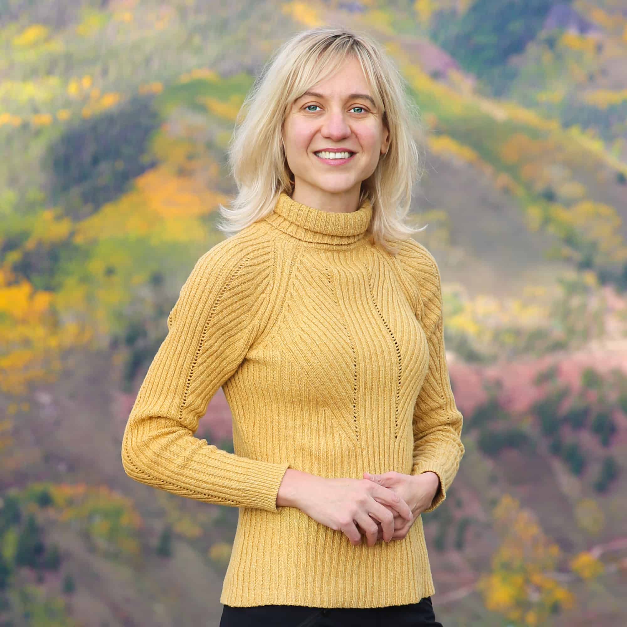 Julia is the author of JuliasAlbum.com (a food blog focused on easy dinner recipes, pasta dishes, salads made with seasonal ingredients). In this photo, Julia is pictured wearing a yellow sweater against an Autumn background.