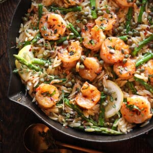 Lemon Shrimp Orzo with Asparagus and Capers - in a cast iron skillet.