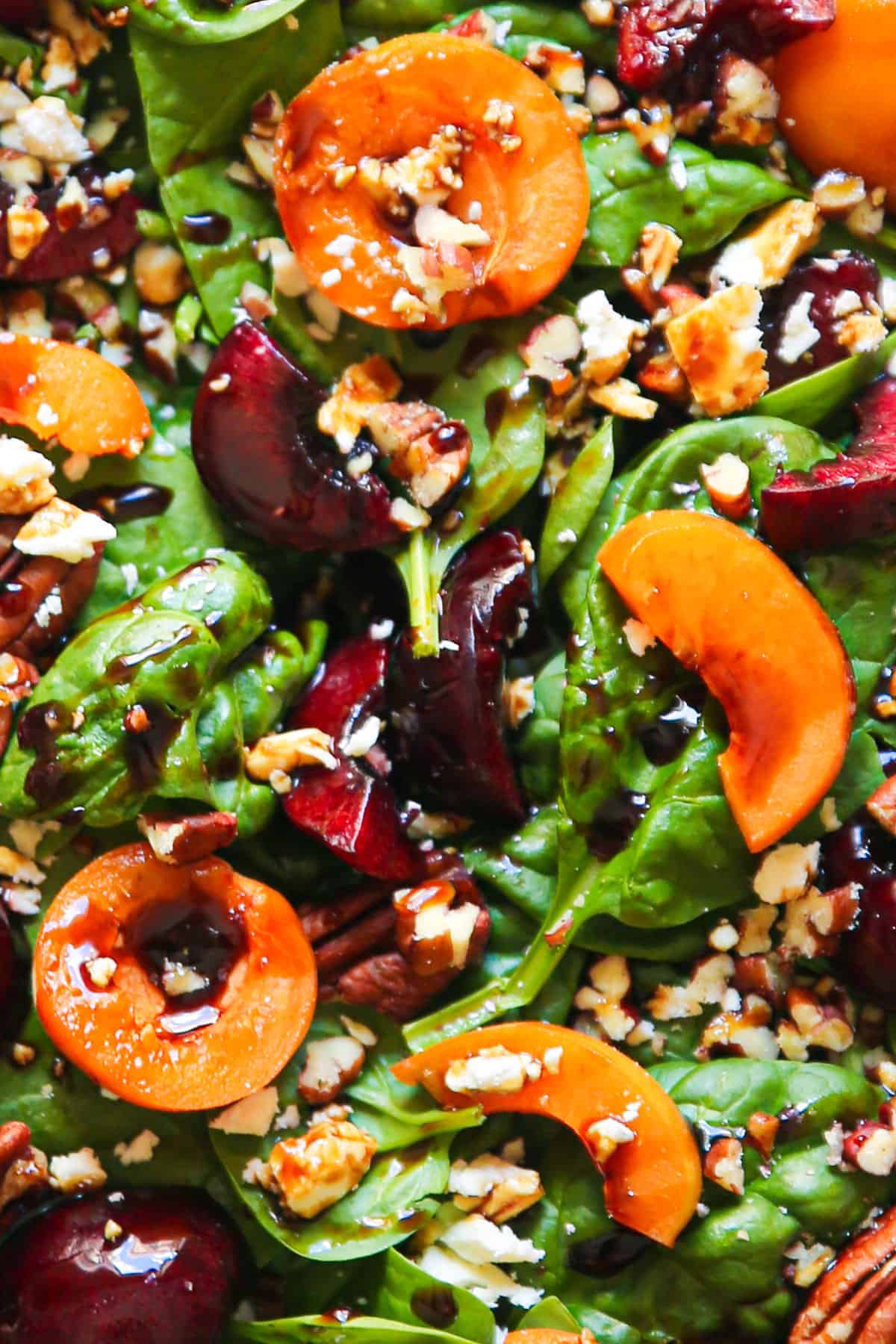 Apricot Salad with Spinach, Cherries, Pecans, Feta Cheese, and Balsamic Glaze - close-up photo.