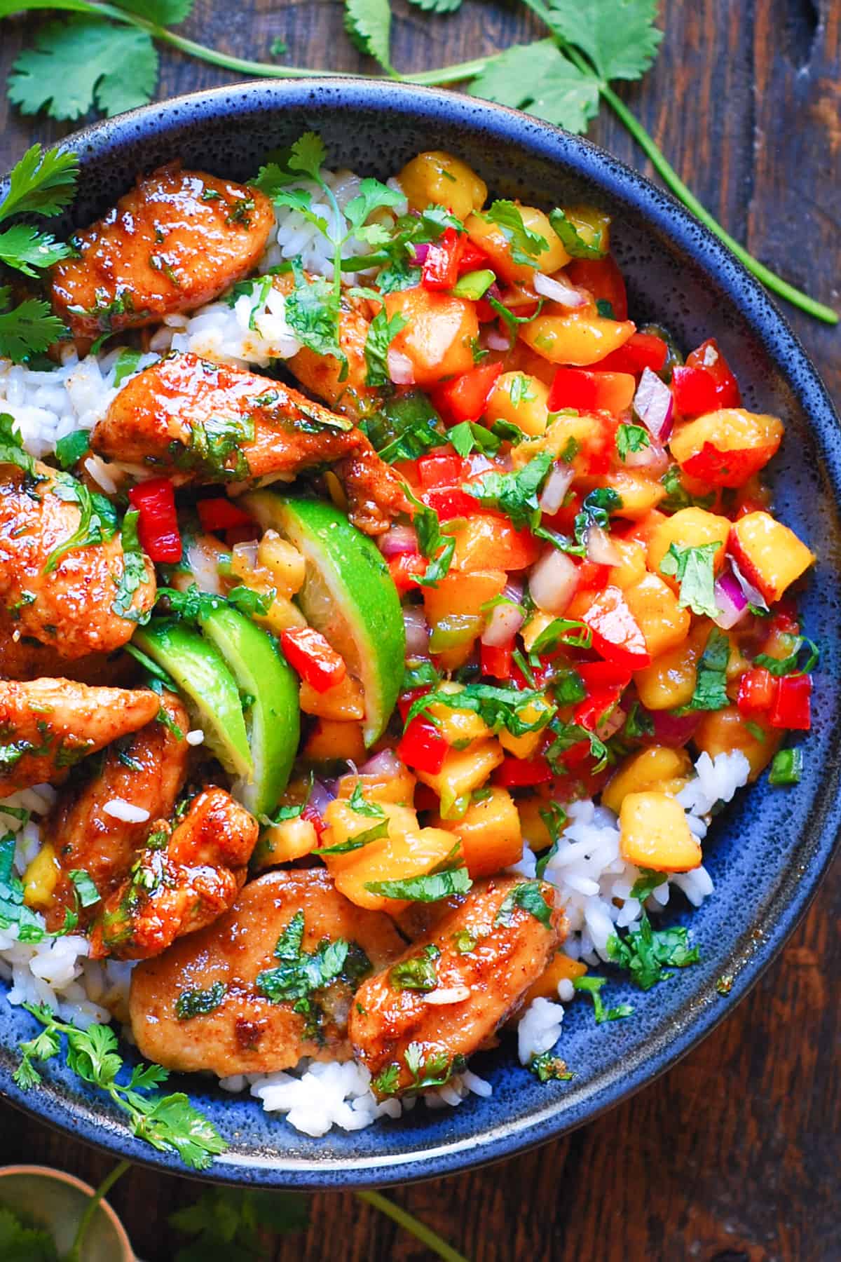 Cilantro-Lime Chicken Bowls with Peach Salsa and Rice in a blue bowl