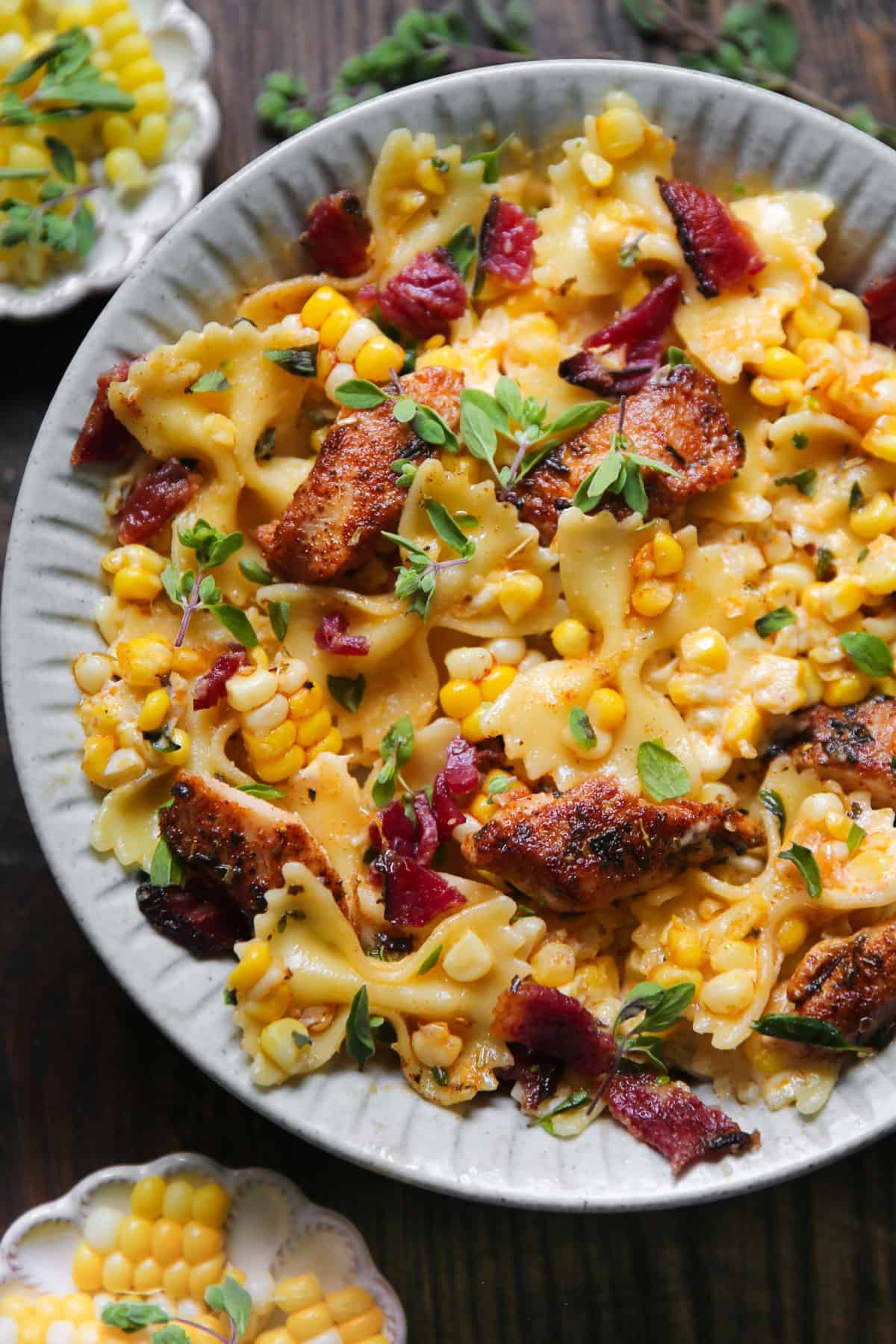 Creamy Chicken and Corn Bow-Tie Pasta with Bacon - on a white plate.