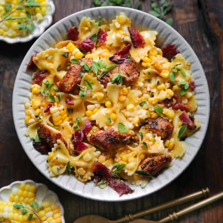 Creamy Chicken and Corn Bow-Tie Pasta with Bacon - on a white plate.