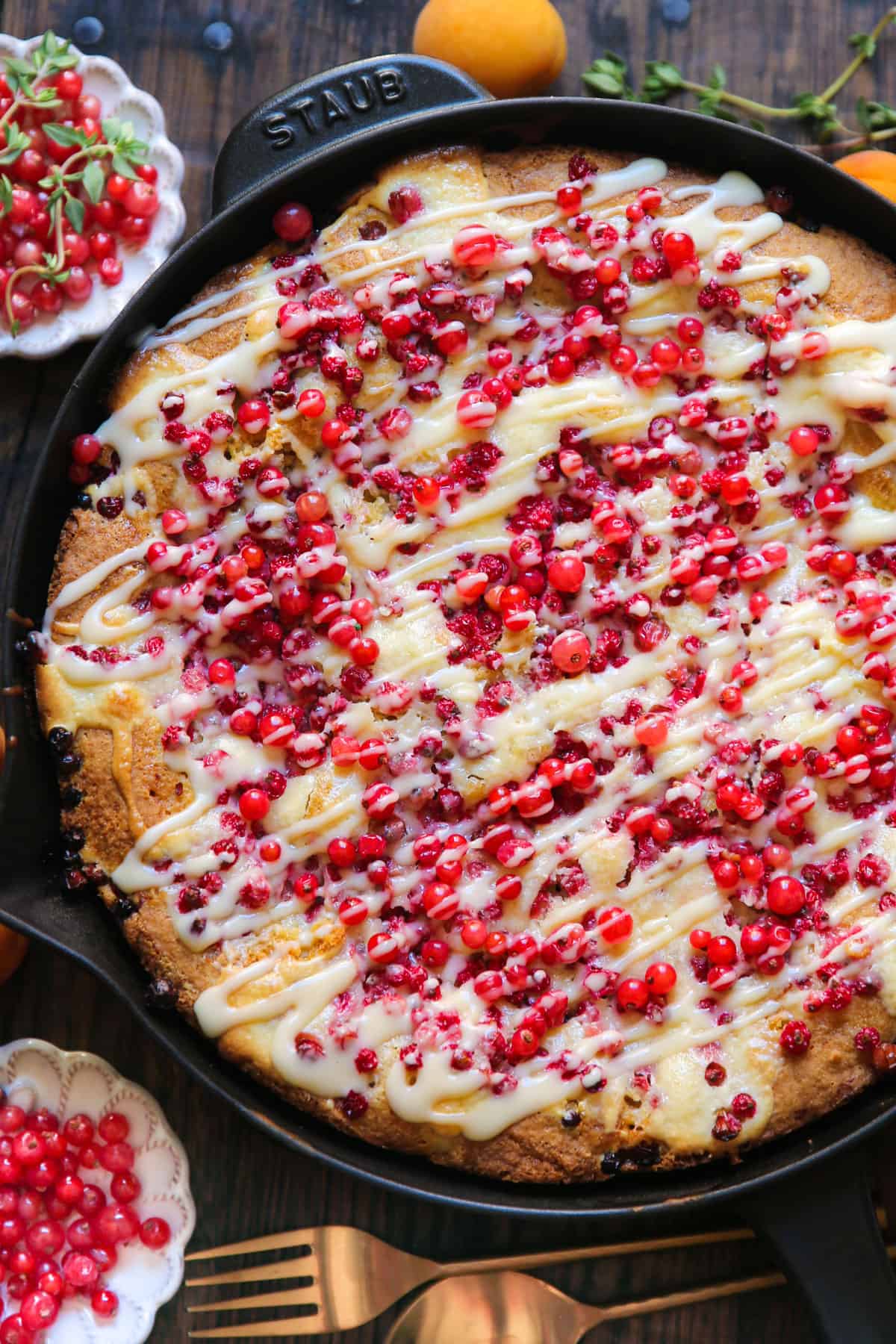 Red Currant Cake with the Cream Cheese Filling and with the Cream Cheese Topping drizzled on top - in a cast iron skillet.