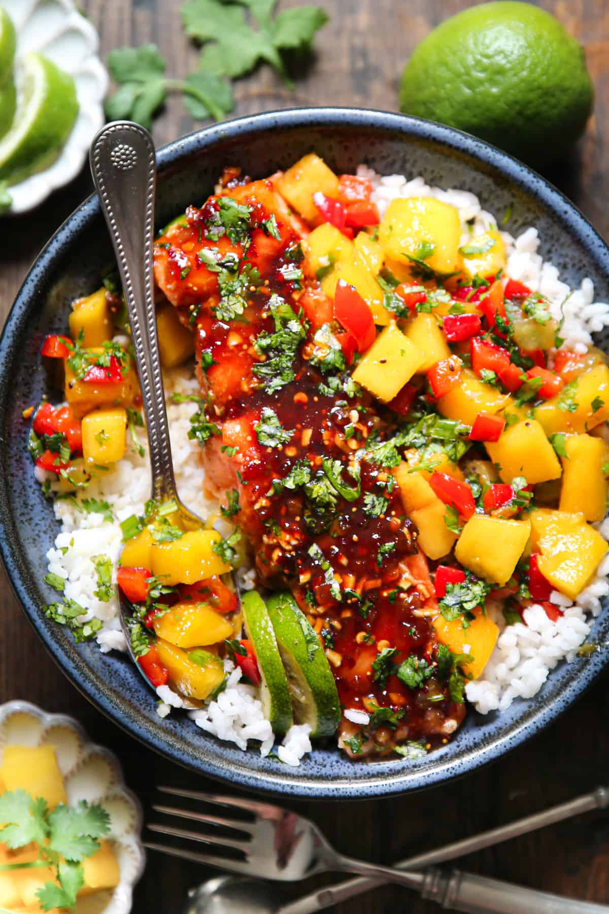 Sweet and Spicy Salmon with Mango Salsa and Rice in a blue bowl