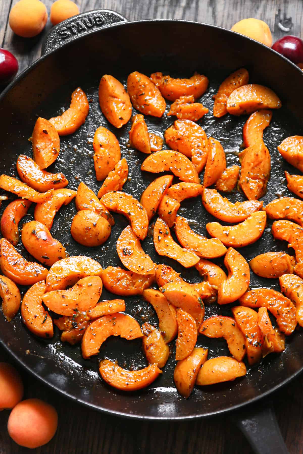 cooked sliced apricots in a cast iron skillet.