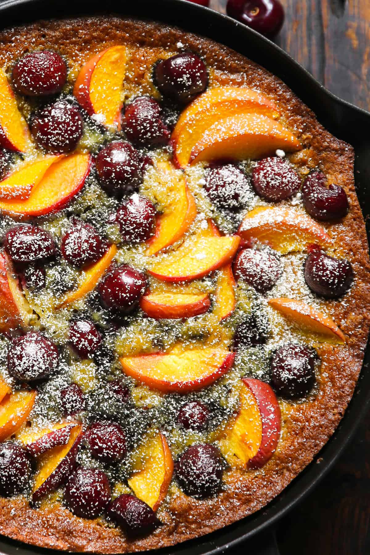 Cherry and Peach Cake in a cast iron skillet.