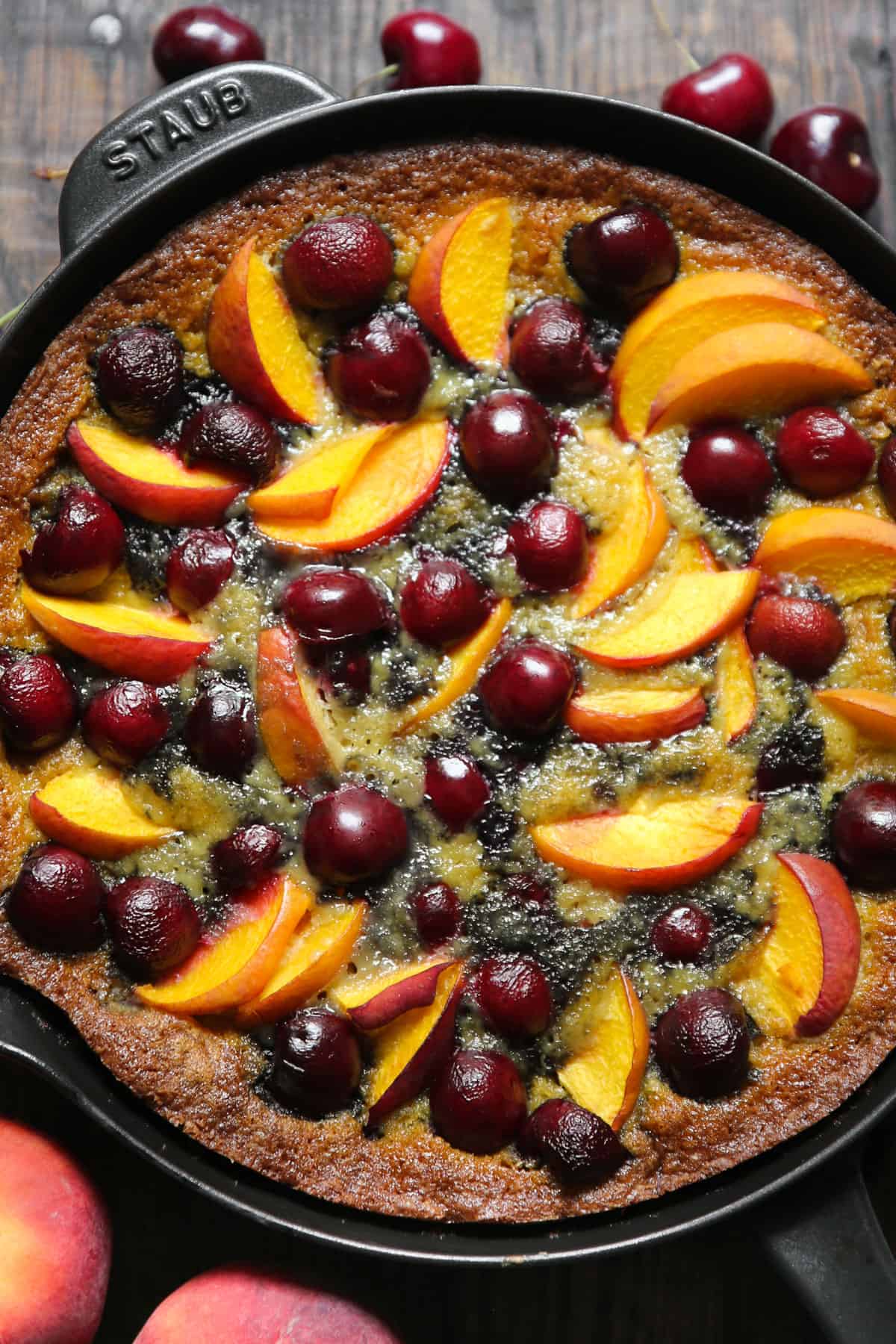 Cherry and Peach Cake in a cast iron skillet.