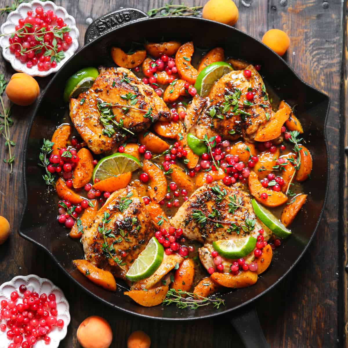 Chicken with Red Currants, Apricots, Honey-Lime Sauce, and Lime Slices - in a cast iron skillet.