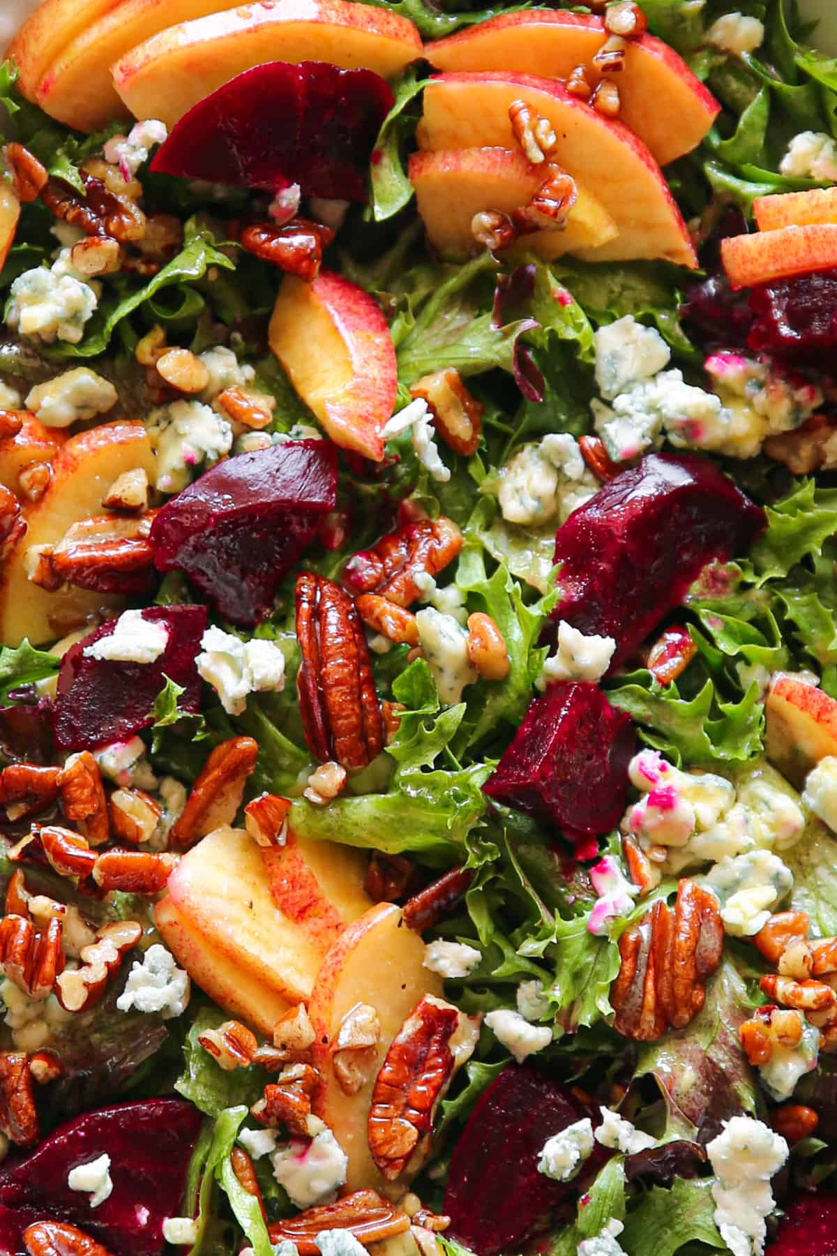 Beet and Apple Salad with Mixed Greens, Pecans, Blue Cheese - close-up photo.