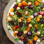 Beet and Mozzarella Cheese Salad with Arugula and Balsamic Dressing - on a white plate.