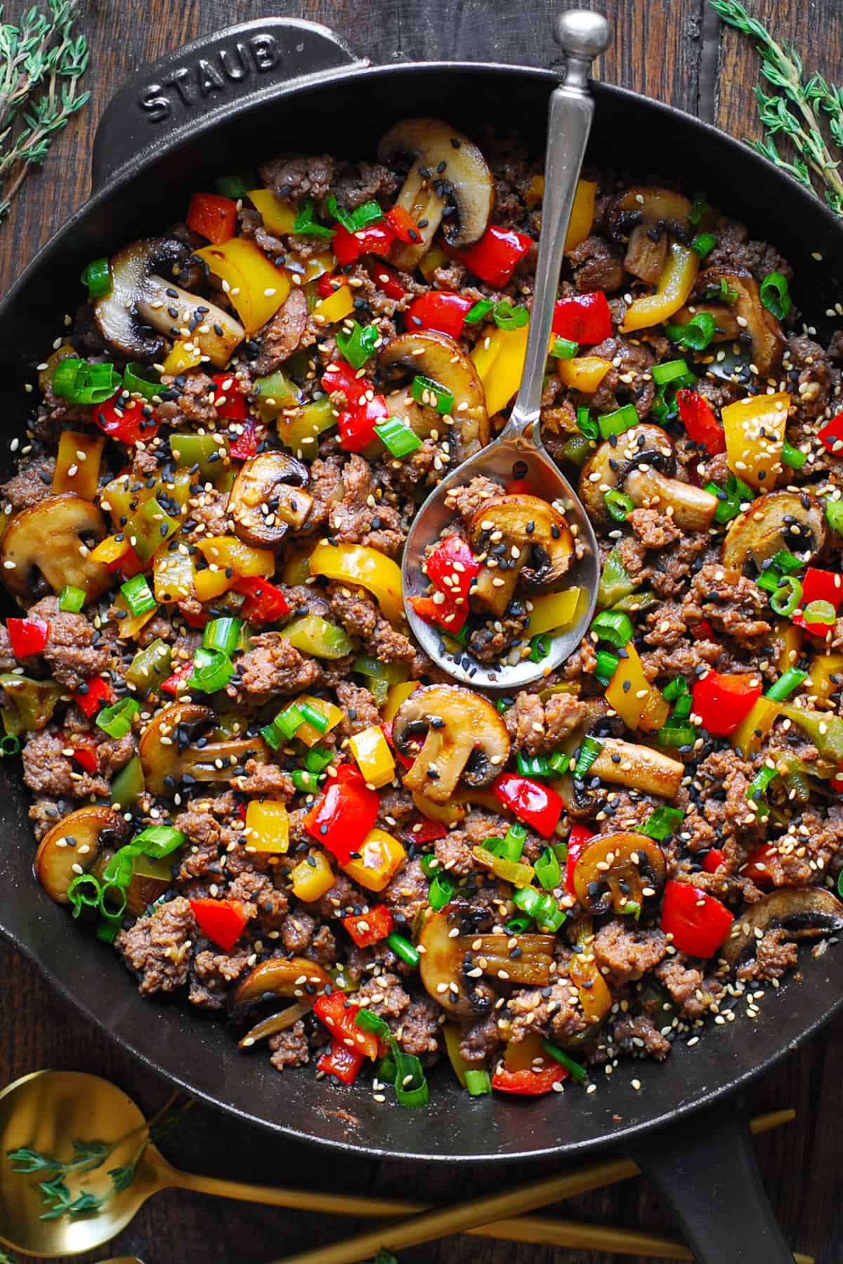 Ground Beef Stir Fry with Bell Peppers, Mushrooms in a cast-iron pan.