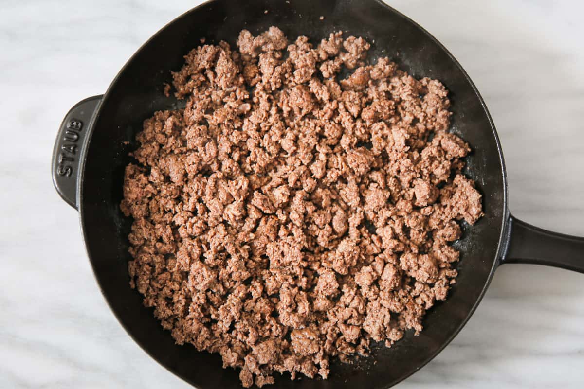 cooked ground beef in a cast iron skillet.