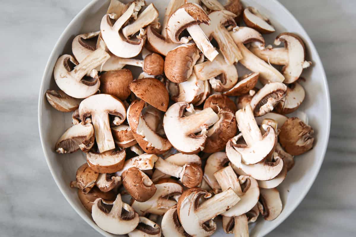 sliced mushrooms on a white plate.