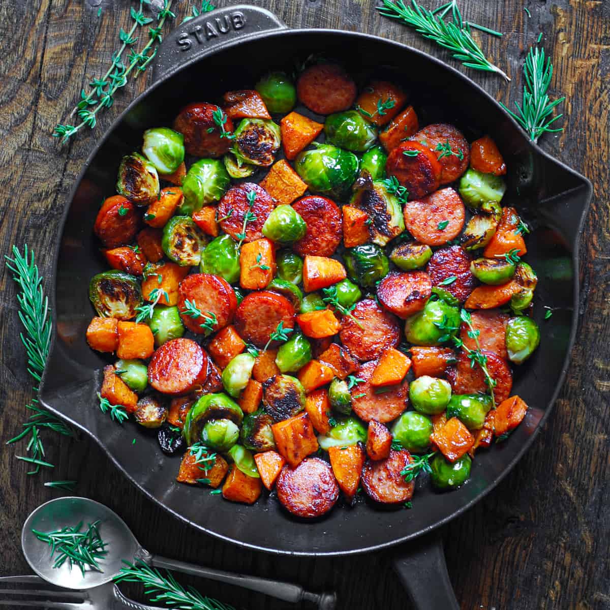 Autumn Sausage Dinner with Roasted Veggies (Butternut Squash and Brussels sprouts) in a cast iron skillet.