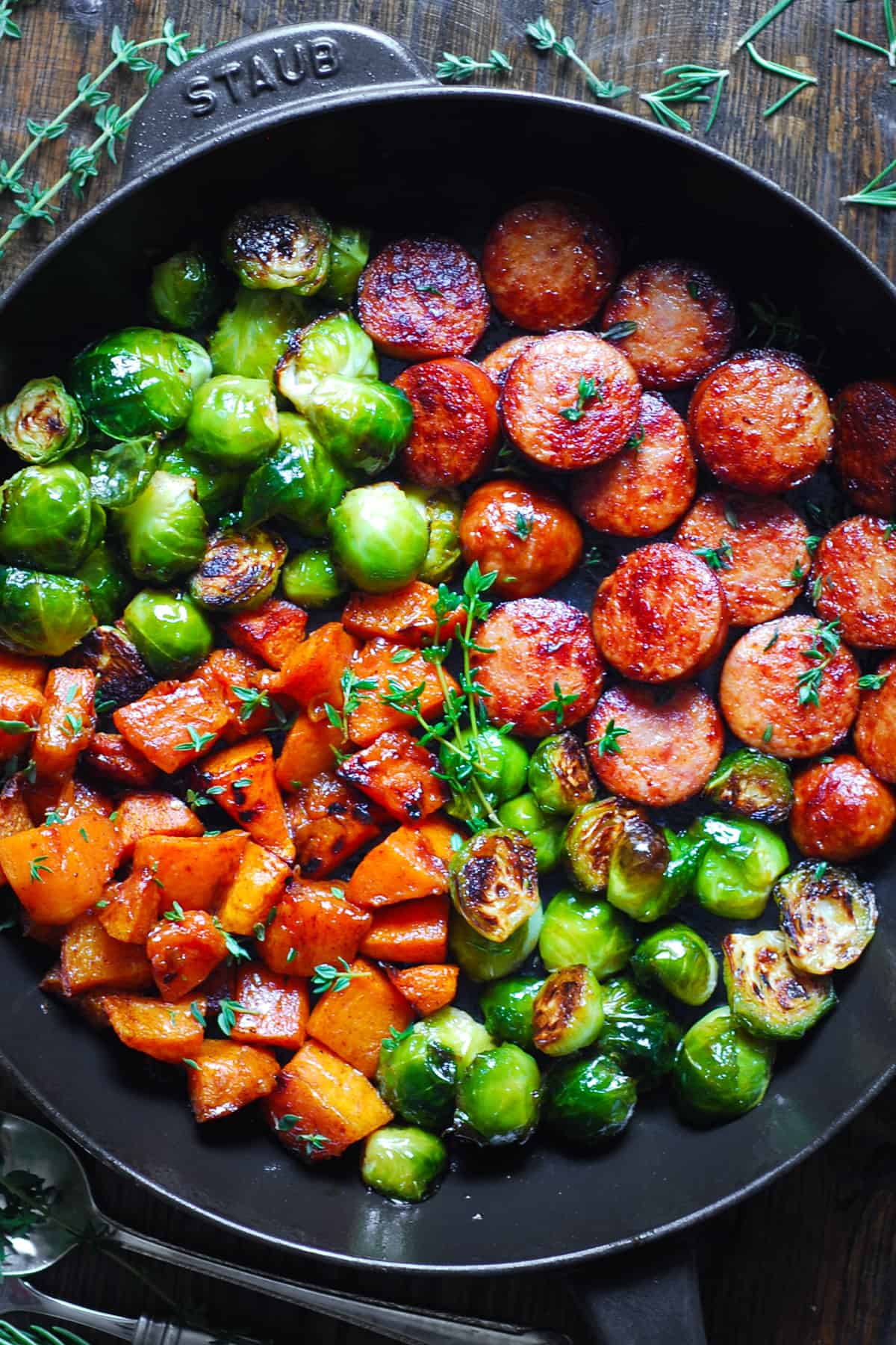 Autumn Sausage Dinner with Roasted Veggies (Butternut Squash and Brussels sprouts) in a cast iron pan.