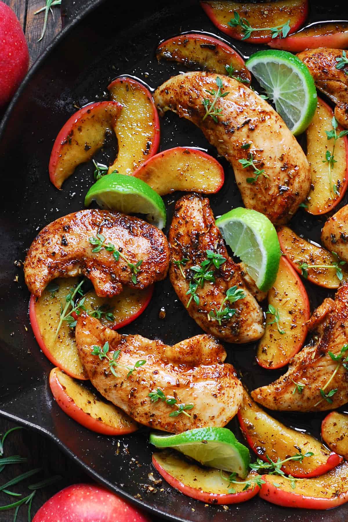 Chicken with Apples, Maple-Lime Sauce, and lime slices - in a cast iron skillet.