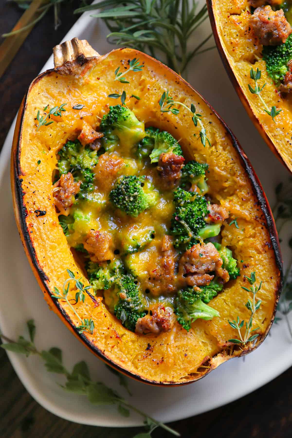 Stuffed Roasted Spaghetti Squash Half with Broccoli, Sausage, and Cheddar Cheese - on a white platter.