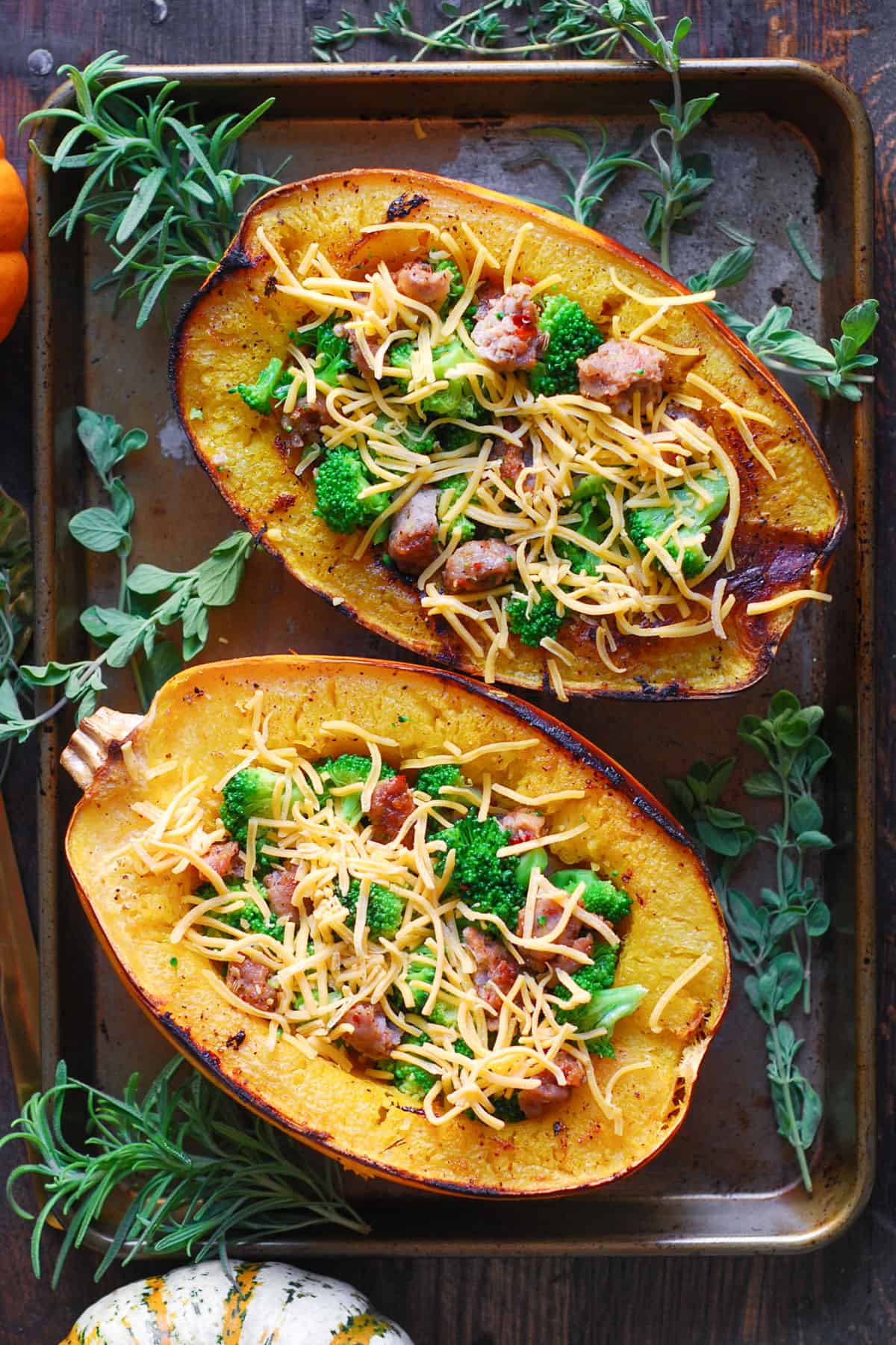 Stuffed Roasted Spaghetti Squash Halves (2) with Broccoli, Sausage, and Cheddar Cheese - on a baking sheet.