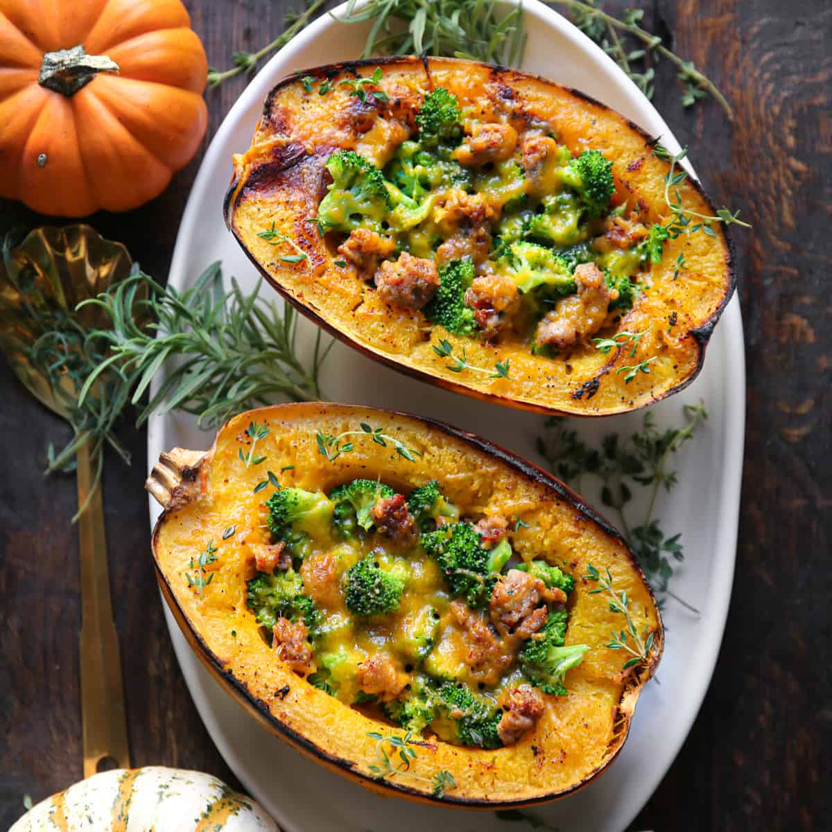 Stuffed Roasted Spaghetti Squash Halves (2) with Broccoli, Sausage, and Cheddar Cheese - on a white platter.
