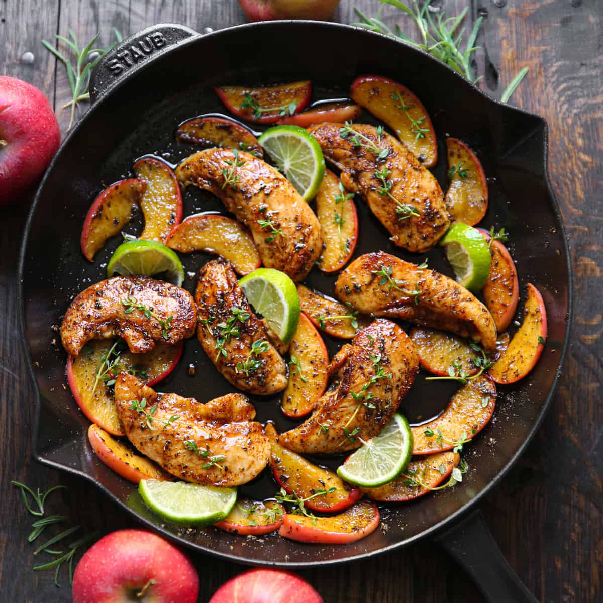 Chicken with Apples, Maple-Lime Sauce, and lime slices - in a cast iron skillet.