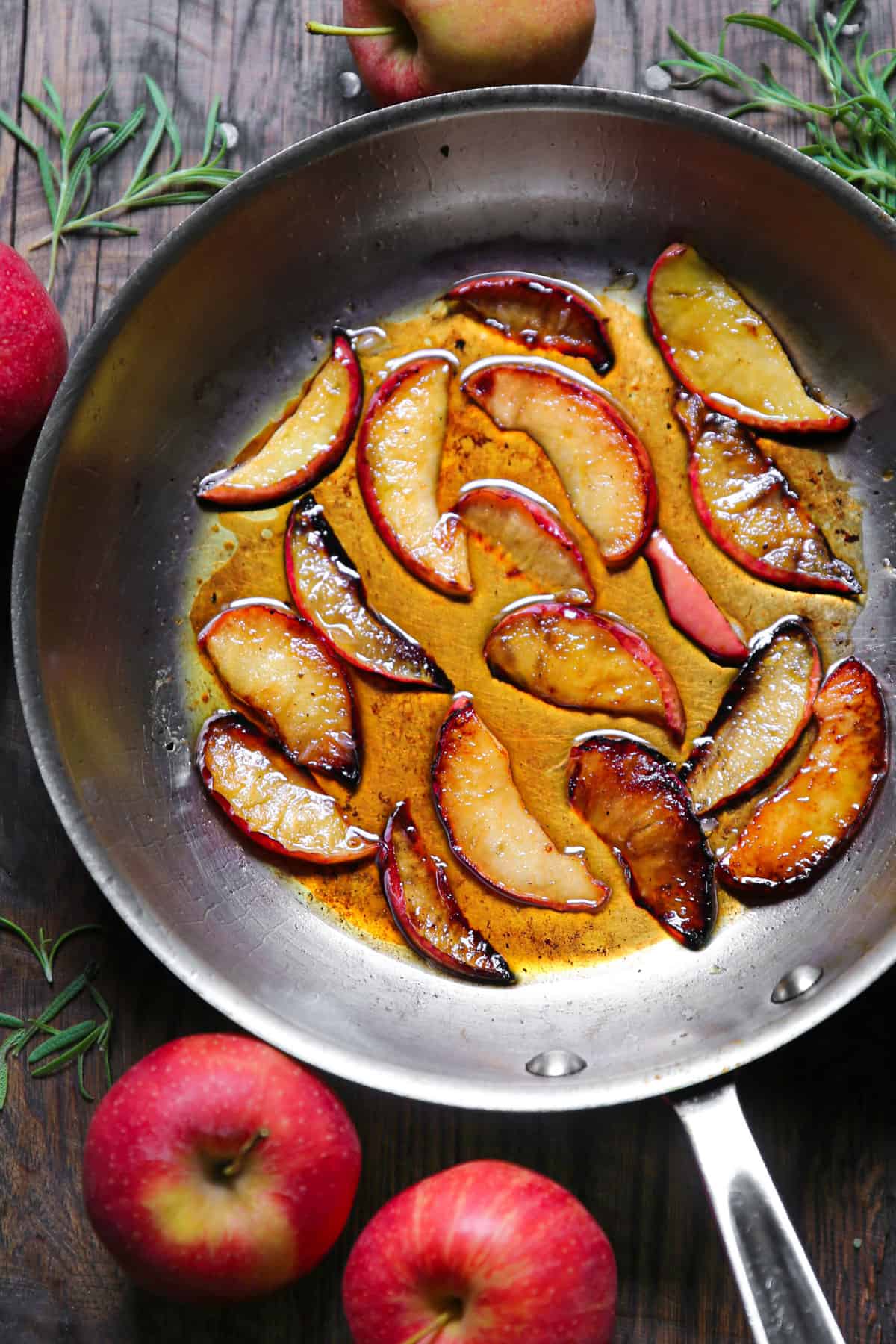 cooked apple slices in a stainless steel skillet