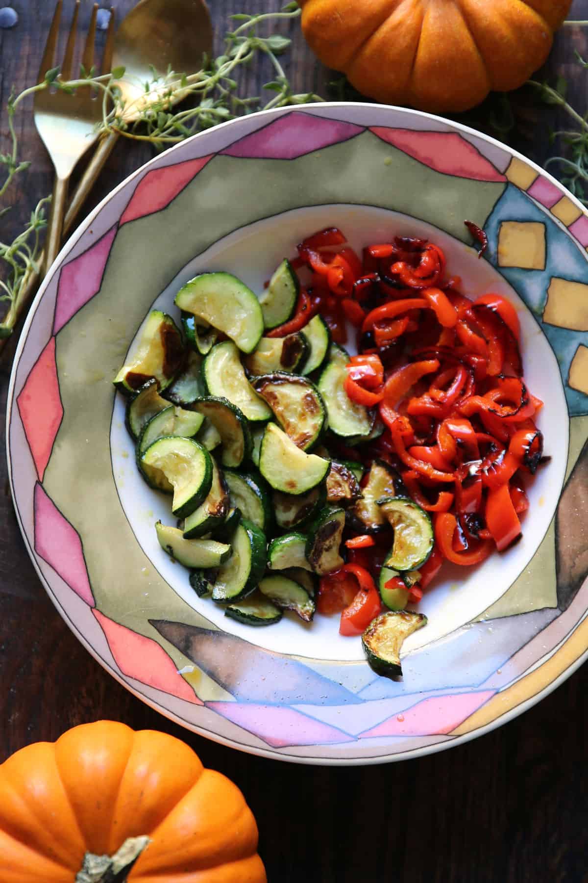 cooked zucchini and bell peppers in a bowl.