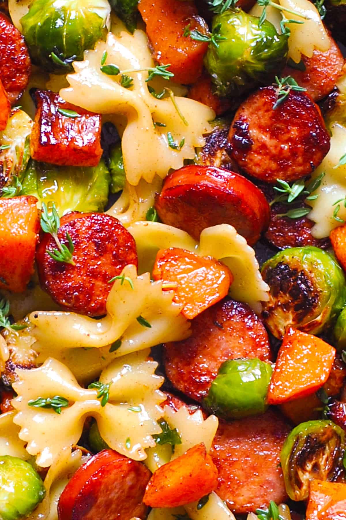 Autumn Dinner with Sausage, Pasta, Veggies (Butternut Squash and Brussels sprouts) - close-up photo.